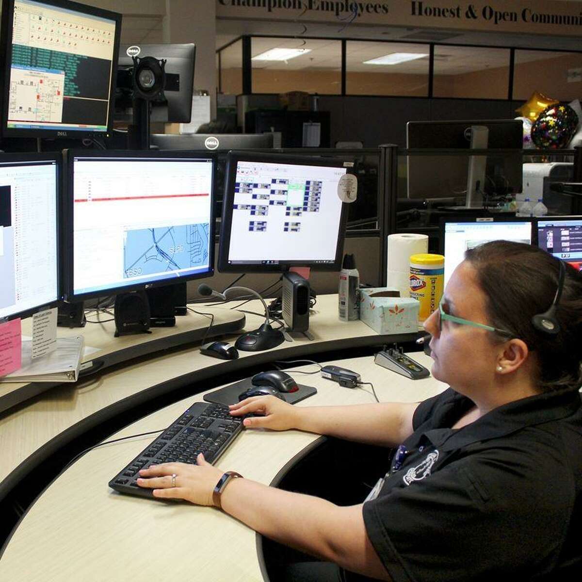 Sugar Land Public Safety Dispatcher Amanda Davis at a public safety dispatch console.