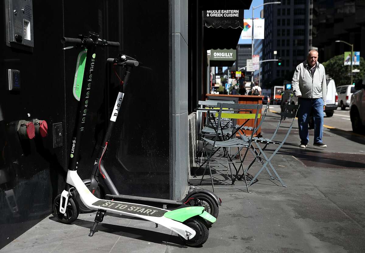 SAN FRANCISCO, CA - APRIL 17: Bird and Lime scooters sit parked in front of a building on April 17, 2018 in San Francisco, California. Three weeks after three companies started placing electric scooters on the streets for rental, San Francisco City Attorney Dennis Herrera issued cease-and-desist notice to electric scooter rental companies Bird, LimeBike and Spin. The notice comes as the San Francisco board of supervisors considers a proposed ordinance to regulate the scooters to keep people from riding them on sidewalks, parking them in the middle of sidewalks and requiring riders to wear helmets and have a drivers license. (Photo by Justin Sullivan/Getty Images)