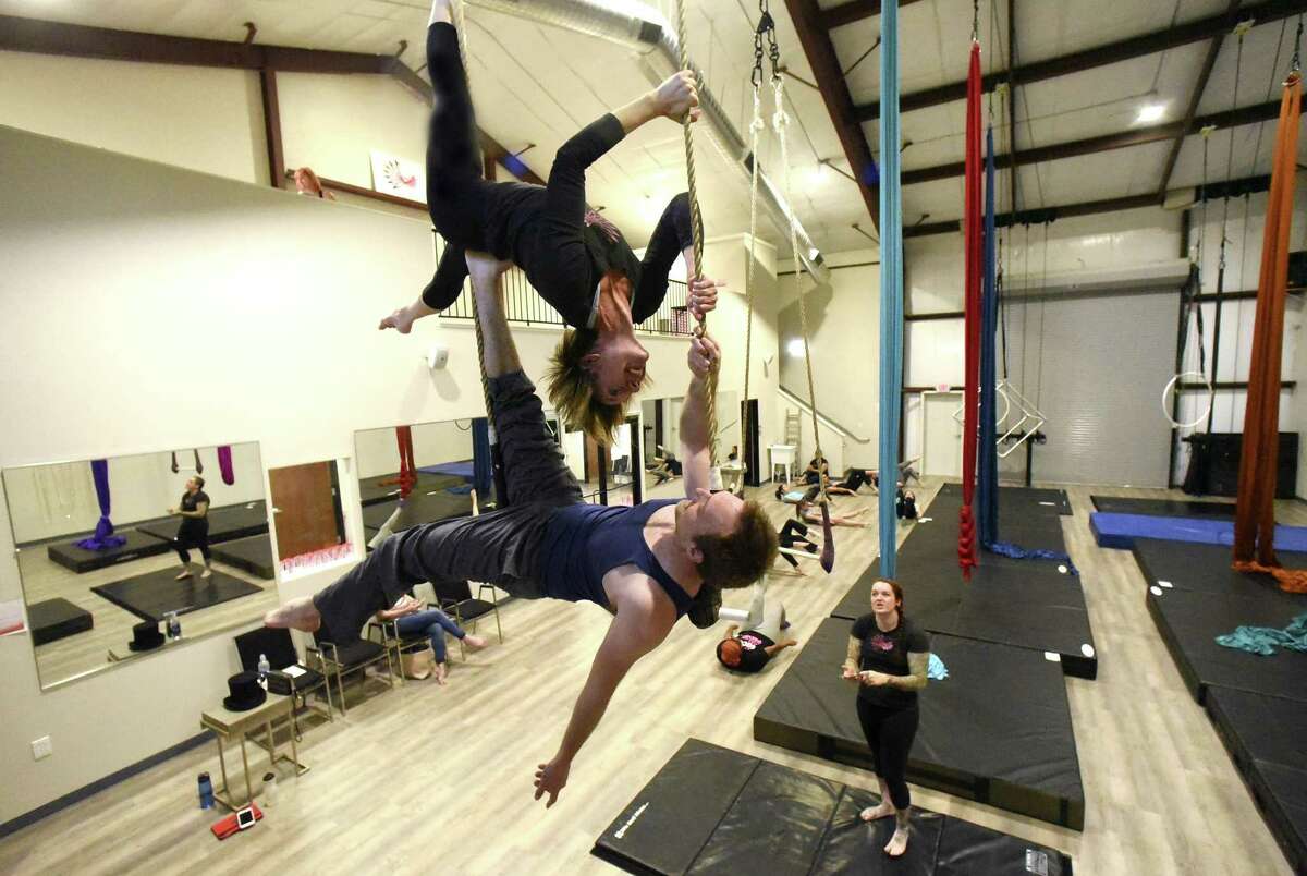 Joshua Grohman and Jenny Franckowiak work out at Aerial Horizon, which is an aerial dance company, in a new facility on Saturday, April 14, 2018.