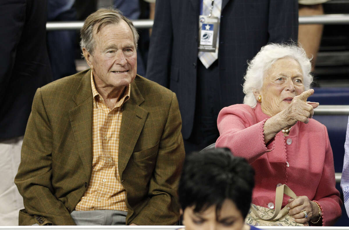Former President George H.W. Bush and wife, Barbara, take their seats before the VCU-Butler game of the men's NCAA Final Four semifinal basketball game in Houston on April 2, 2011. Barbara Bush died Tuesday. She was 92.