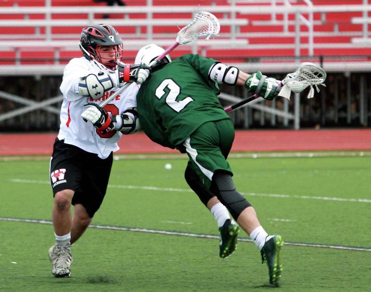 Norwalk's Alton Hall (2) charges into Fairfield Warde's Ryan Janz (19) as he drives towards the goal during boys lacrosse action in Fairfield, Conn., on Tuesday Apr. 17, 2018.