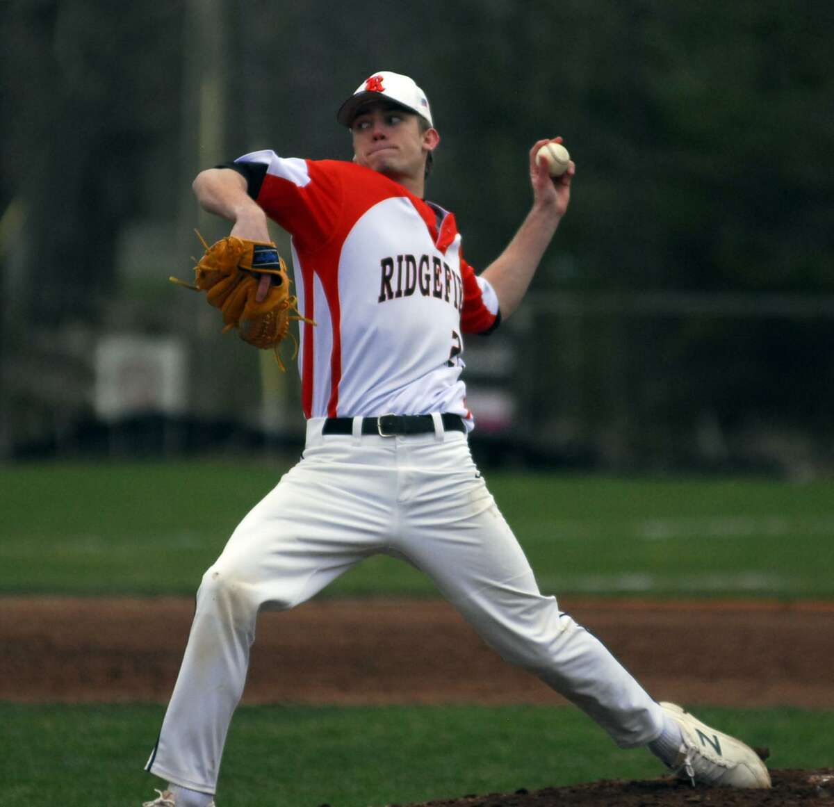 Ridgefield’s Alex Price tosses a pitch during a game against Danbury on Tuesday.