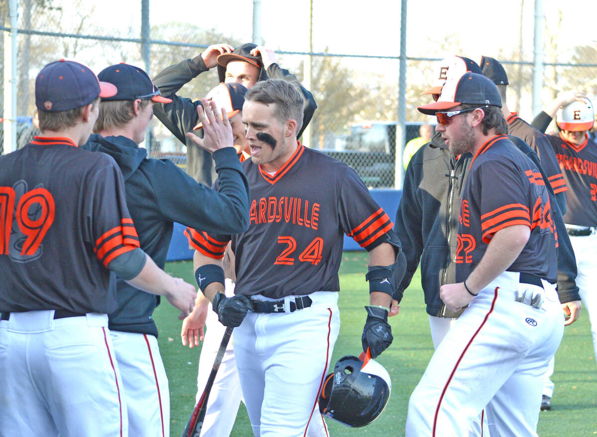 Edwardsville senior Reid Hendrickson, middle, is congratulated by his teammates after hitting a game-tying two-run homer in the top of the sixth inning on Tuesday at O’Fallon.
