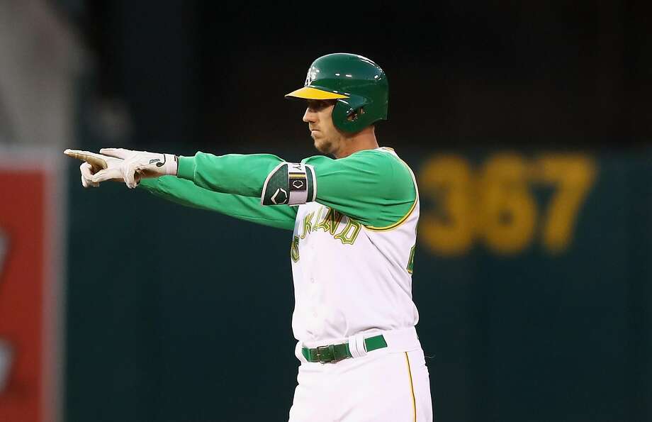 athletics points back to the dugout after he hit a two-run