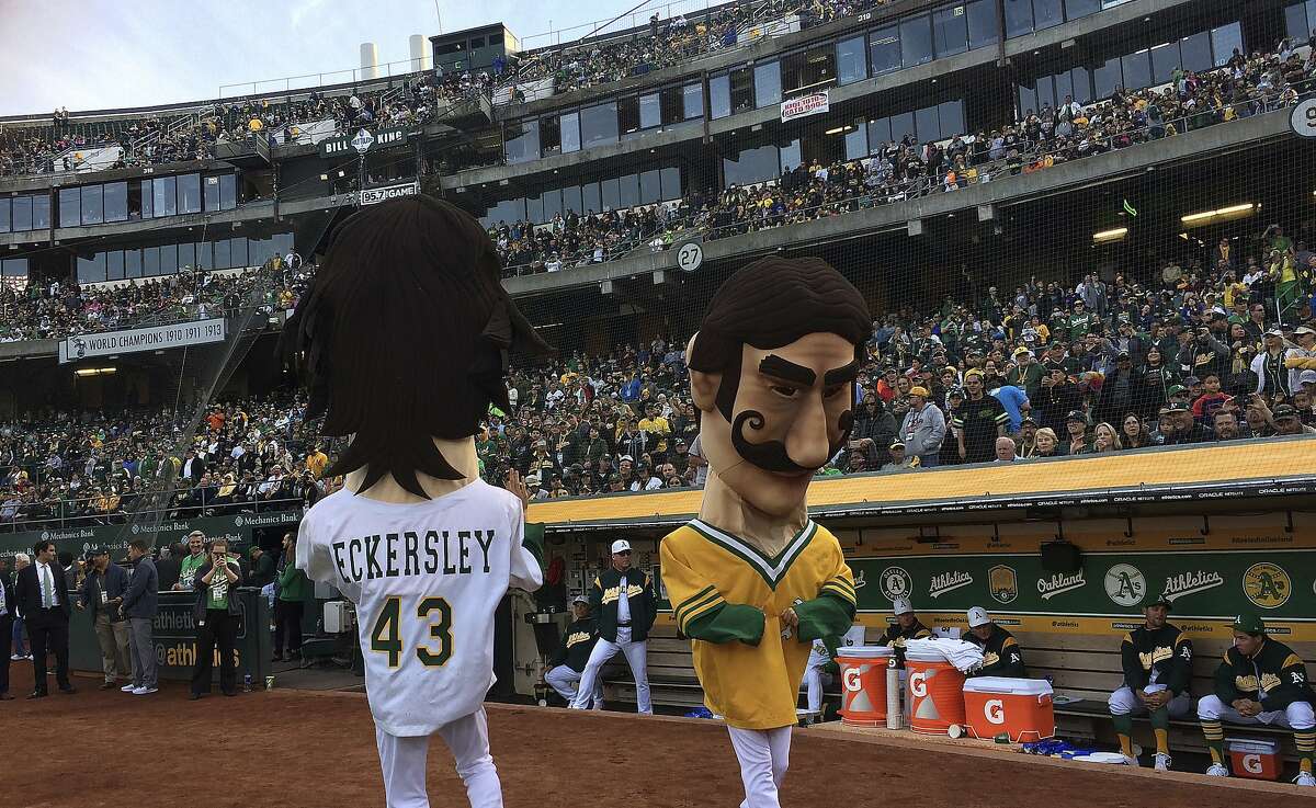 Oakland Athletics mascots resembling Dennis Eckersley (43) and Rollie Fingers entertain fans prior to the team's baseball game against the Chicago White Sox on Tuesday, April 17, 2018, in Oakland, Calif. The A's hosted a "Free Baseball" night at the stadium, to celebrate the A's first game in Oakland, which was held exactly 50 years ago against the Baltimore Orioles. (AP Photo/Ben Margot)