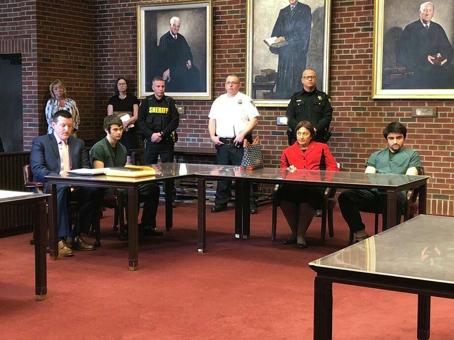 Convicted killers Joseph Broscko, left in green jumpsuit, and Nikolai Mavashev, at right in green jumpsuit sit with their lawyers, Mattherw Chauvin and Cheryl Coleman, respectively, as they await sentencing for the killing last year of David Feliciano. Photo: Skip Dickstein / Times Union