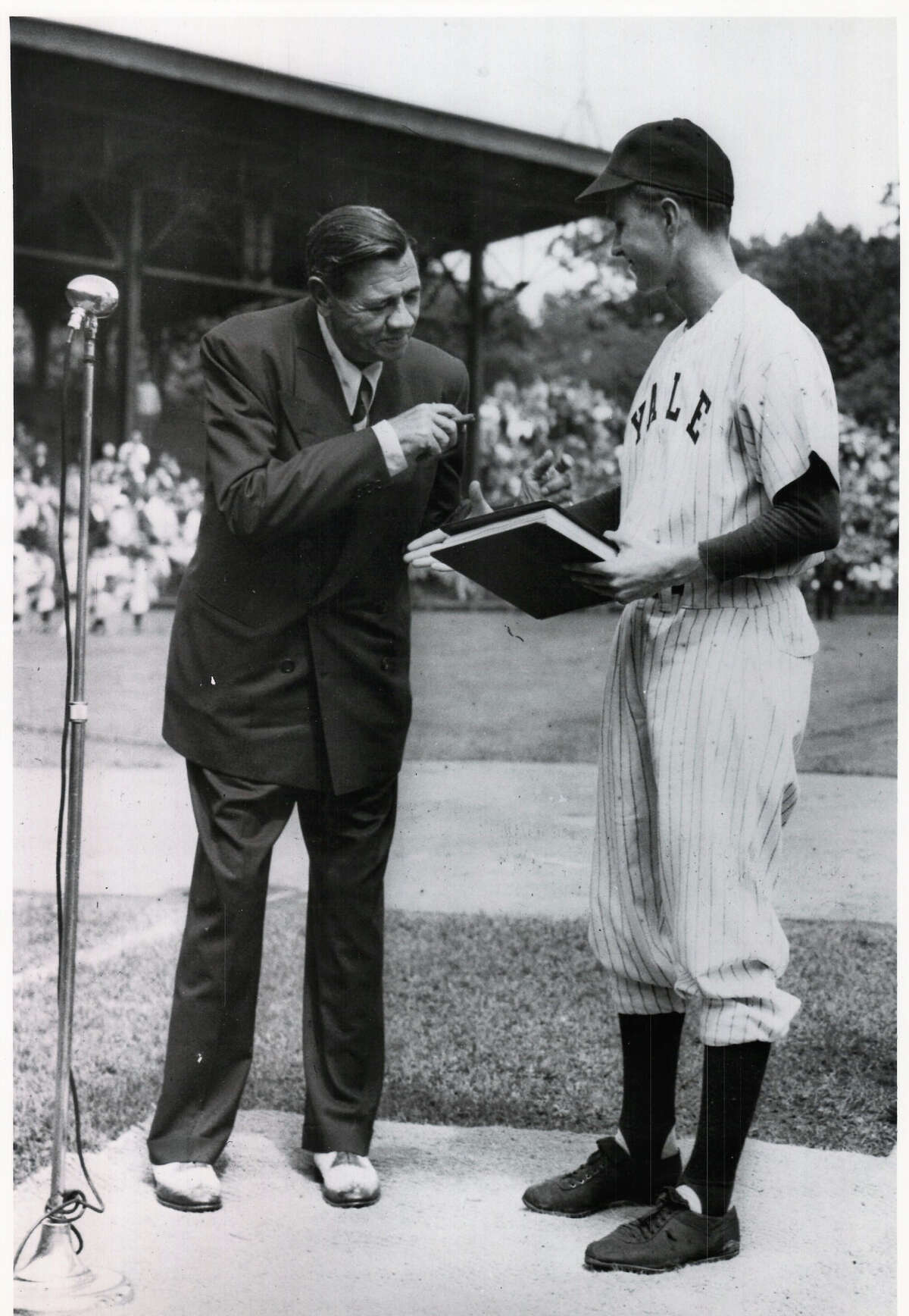 George H.W. Bush welcomes "Babe" Ruth at a pre-game ceremony at the Yale University Field in June 1948. Bush was then captain of the 1948 varsity team. It was one of Ruth's last public appearances as he died later that summer. The photo notes it was donated to the New Haven Register on May 31, 1991 by the Yale University Office of Official Affairs