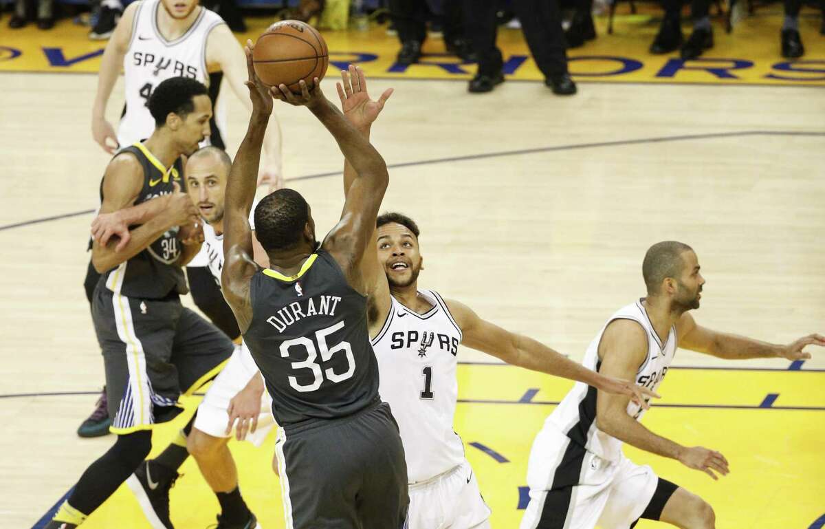 San Antonio Spurs' Kyle Anderson tries to defend against Golden State Warriors' Kevin Durant in the second quarter during game 2 of round 1 of the Western Conference Finals at Oracle Arena on Monday, April 16, 2018 in Oakland, Calif.