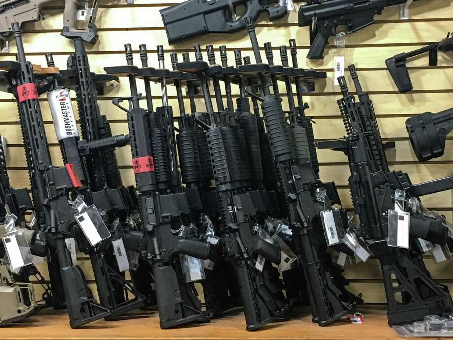 Semi-automatic rifles are seen for sale in a gun shop in Las Vegas, Nevada on October 4, 2017.  
Mass killer Stephen Paddock used semi-automatic weapons which he modified with "bump-fire stock" to make them fire at the same speed as a fully automatic weapon when he killed 58 people and injured over 500 in the worst mass shooting in modern American history on October 1, 2017 at a country music festival in Las Vegas. / AFP PHOTO / Robyn BeckROBYN BECK/AFP/Getty Images ORG XMIT: Trump tra Photo: ROBYN BECK / AFP or licensors