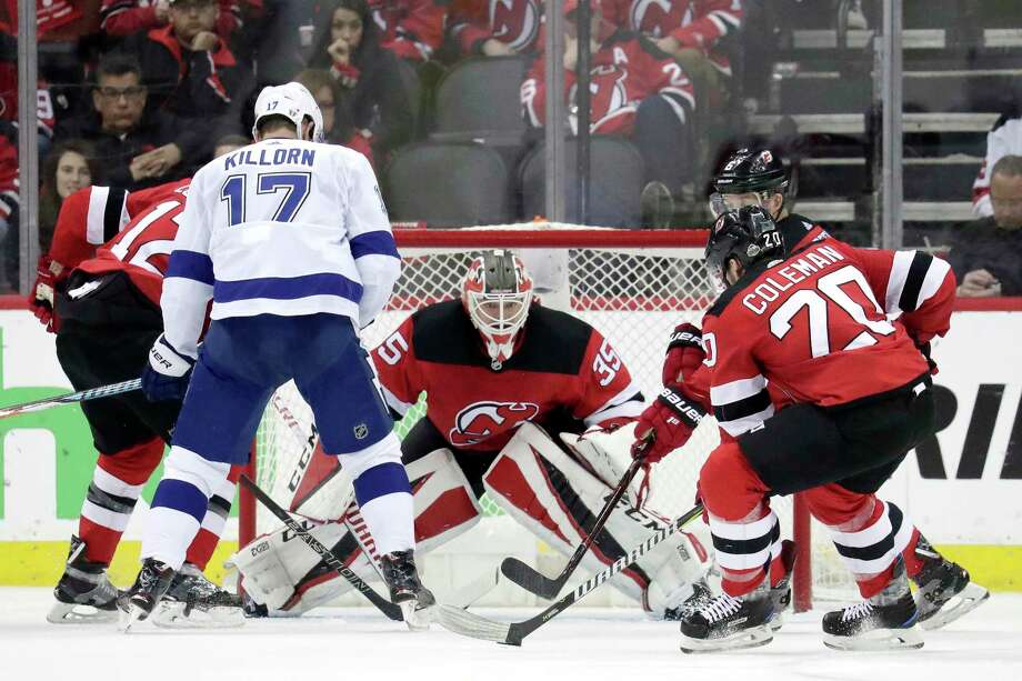 New Jersey Devils goaltender Cory Schneider, center, eyes the puck as teammates defend against Tampa Bay Lightning left wing Alex Killorn (17) during the second period of Game 4 of an NHL first-round hockey playoff series, Wednesday, April 18, 2018, in Newark, N.J. (AP Photo/Julio Cortez) Photo: Julio Cortez / Copyright 2018 The Associated Press. All rights reserved.