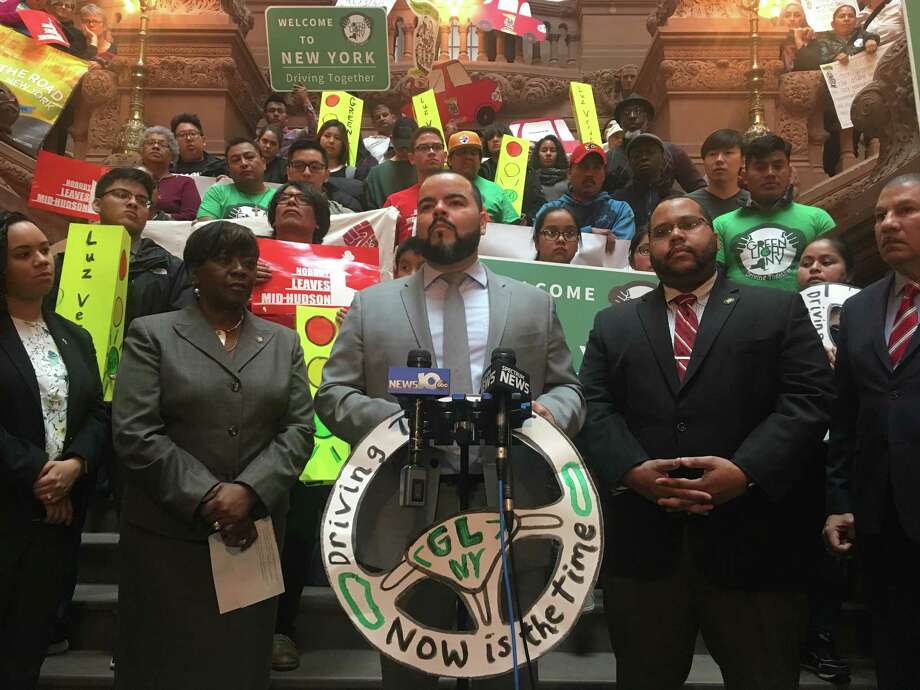 Activists and Assembly members, including Assemblyman Marcos Crespo (center), rally in the Capitol on Wednesday for legislation allowing undocumented New Yorkers to obtain drivers' licenses. Photo: David Lombardo