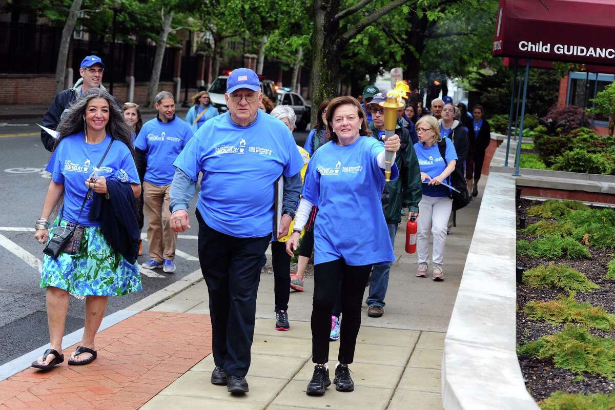 Shirley Brazel Sklar, right, and husband Bill Sklar carry the torch through the first leg of the JCC Maccabi Torch Relay on Sunday, May 22, 2016. JCC officials, including Sherman, argue the club could chip away at their memberships enough to force them to close. 