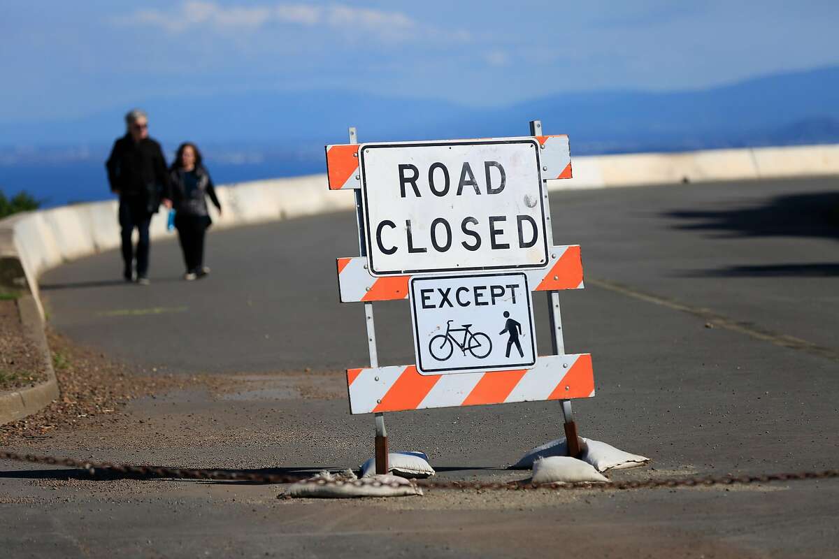 Bob (l to r) and Mona Small of Philadelphia, PA. walk along half of the figure-eight road at the top of Twin Peaks which has been closed during a pilot program on Wednesday, April 18, 2018, in San Francisco, Calif.