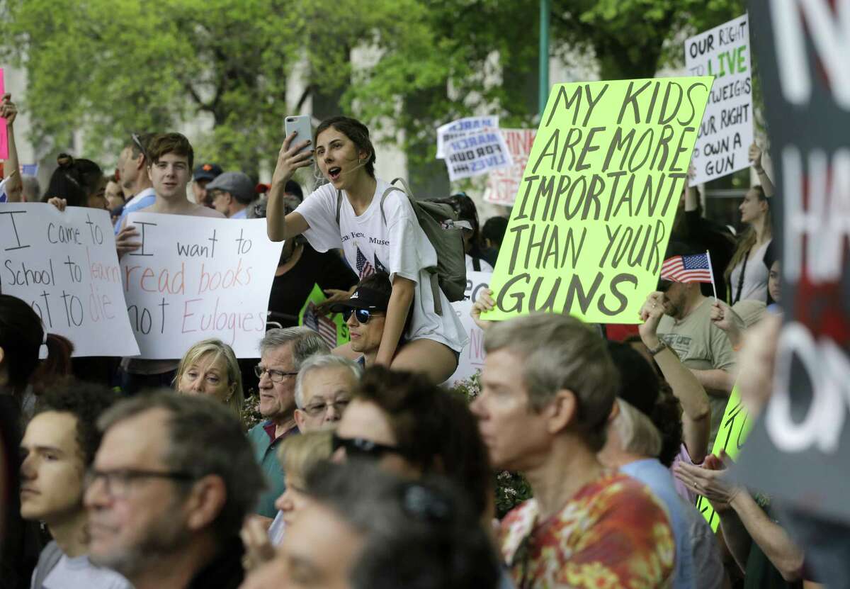 In this March file photo, people listen to speeches during a rally at Tranquility Park as they participate in the March For Our Lives in downtown Houston. ( Melissa Phillip / Houston Chronicle)