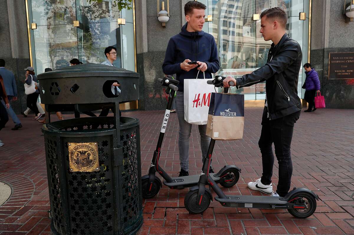 Leo Dubler, (left) and Bastien Ruch, visiting from Switzerland check out two Bird scooters for the first time, along Market st. in San Francisco, Calif., as seen on Mon. April 9, 2018.