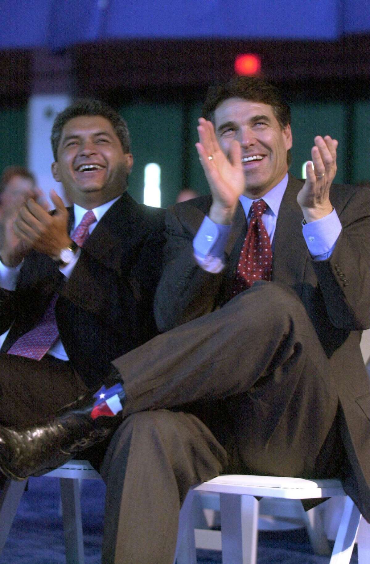 In this 2001 photo, then-Texas Gov. Rick Perry (right) and then-Tamaulipas Gov. Tomás Yarrington laugh as they listen to a speech by Fernando Canales Clariond, governor of the Mexican state of Nuevo Leon.