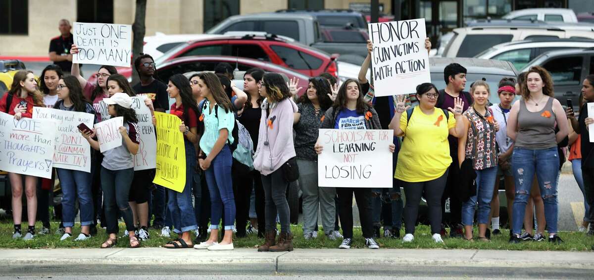 Students at Churchill High School walked out of class to gather on the sidewalk in front of the school along Blanco Rd on Friday, April 20, 2018 to participate in the National School Walkout to protest gun violence in the wake of the Parkland shootings.