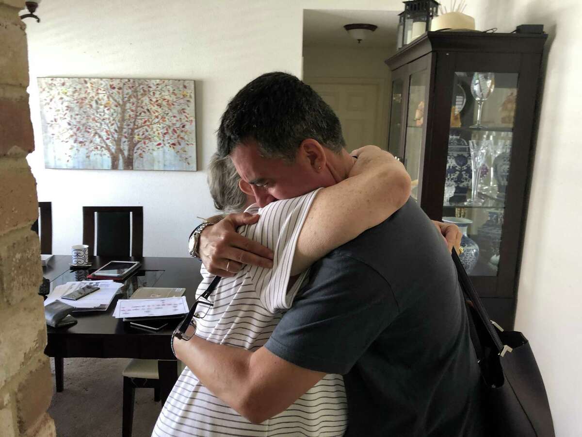 John Wayne Nelson hugs his newly discovered cousin Janice Brady French. Born and raised in France, Nelson used DNA analysis to track down his family in America.