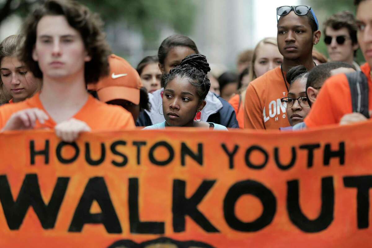 High school students wait in silence before walking after the presentation during the Houston Youth Walkout, a march to coincide with the anniversary of Columbine High School shooting on Friday, April 20, 2018, in Houston. The students walked from Carnagie Vanguard High School in Montrose to Houston City Hall.
