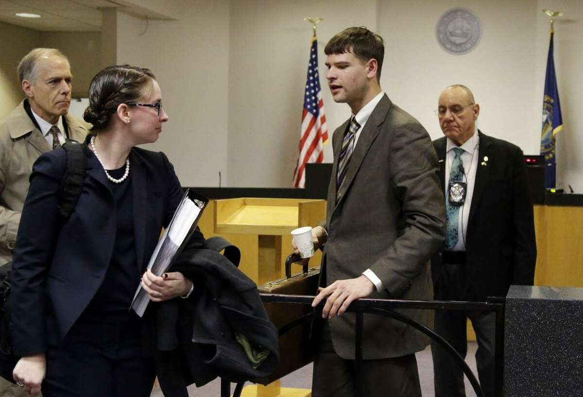 Nathan Carman, second from right, a Vermont man accused by family members of killing his millionaire grandfather and possibly his mother, who lived in Middletown, in an attempt to collect inheritance money, prepares to leave district court April 3 in Concord, N.H., after a hearing to request more information from him.