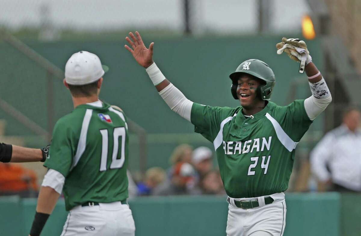 Reagan's Porter Brown,24, celebrates the first run with Ben Sanchez in the first inning from the District 26-6A high school baseball game between Madison and Reagan on Friday, April 20 ,2018 at Blossom Athletic Center.