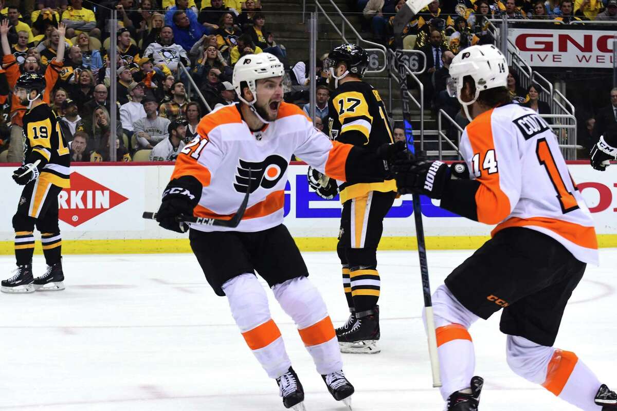 PITTSBURGH, PA - APRIL 20: Scott Laughton #21 of the Philadelphia Flyers celebrates Sean Couturier's #14 game winning goal against the Pittsburgh Penguins in Game Five of the Eastern Conference First Round during the 2018 NHL Stanley Cup Playoffs at PPG PAINTS Arena on April 20, 2018 in Pittsburgh, Pennsylvania. (Photo by Matt Kincaid/Getty Images)