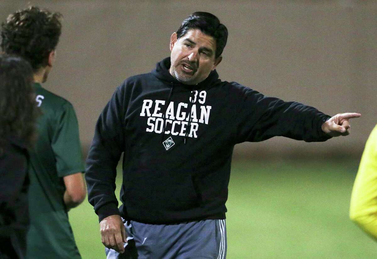 Rattler coach Gilbert Villareal directs a player on the field in the second half as Reagan plays Coppell in the UIL Class 6A state semifinal boys soccer match at Birkelbach Field in Georgetown on April 20, 2018.
