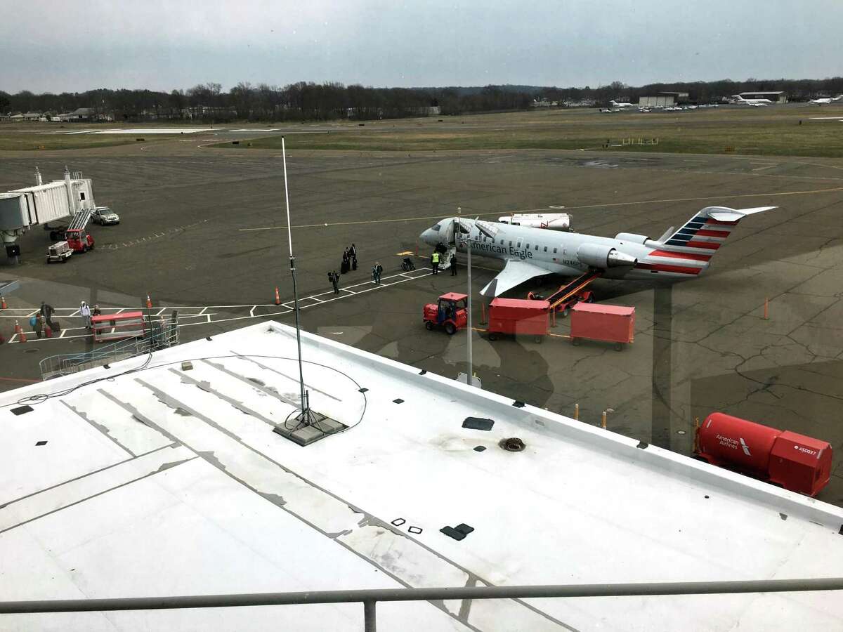 A view of Tweed New Haven Airport through windows of the old tower, now the office of Timothy Larson. The main runway leading toward a neighborhood on the New Haven-East Haven line and the row of houses right across Burr Street from the terminal.