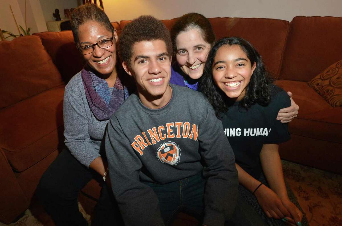 Chaz Bethel-Brescia sits with his family, his mothers Phyllis Bethel and Tina Brescia and sister Nia on Tuesday April 17, 2018 in Norwalk Conn. Chaz was accepted to four ivy league shools and MIT, his senior essay was about his experience being raised by two mothers.