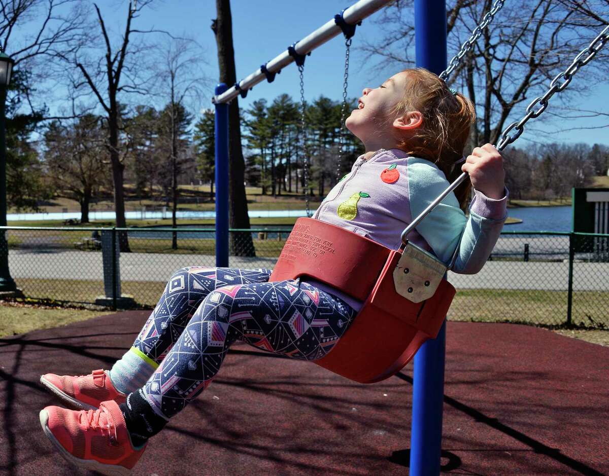 Four-year-old Lyanna Welch of Schenectady seems to be enjoying the feel of the sun on her face as she swings at the playground in Central Park Saturday April 21, 2018 in Schenectady.NY. (John Carl D'Annibale/Times Union)