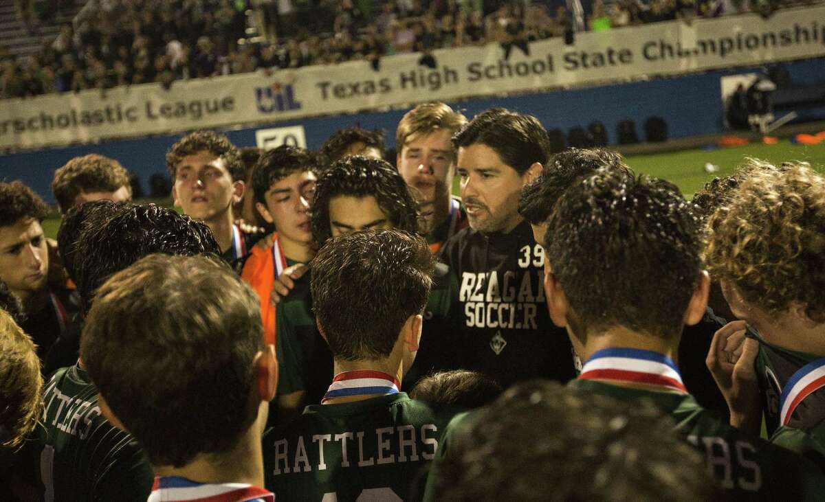 Reagan head coach Gilbert Villarreal talks to his players after their loss to Alief Elsik during their UIL 6A boys State semifinal soccer game at Birkelbach Field on April 21, 2018 in Georgetown, Texas.