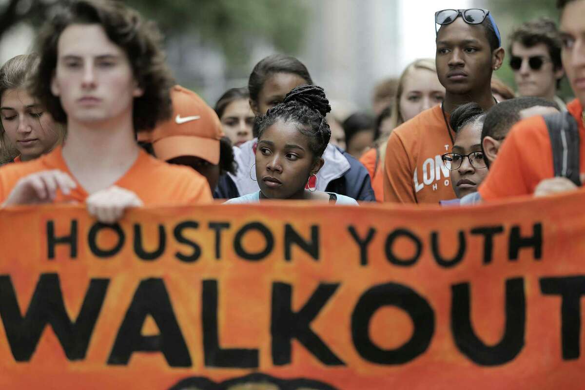 High school students on Friday wait in silence before walking after the presentation during the Houston Youth Walkout, a march to coincide with the anniversary of Columbine High School shooting.