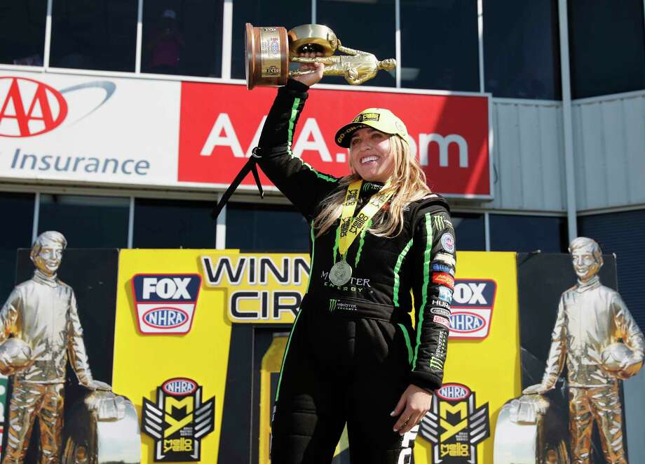 Top Fuel driver Brittany Force celebrates with the championship trophy after the the 31st annual NHRA SpringNationals at the Royal Purple Raceway on Sunday, April 22, 2018 in Baytown, TX. Photo: Tim Warner, For The Chronicle / Houston Chronicle
