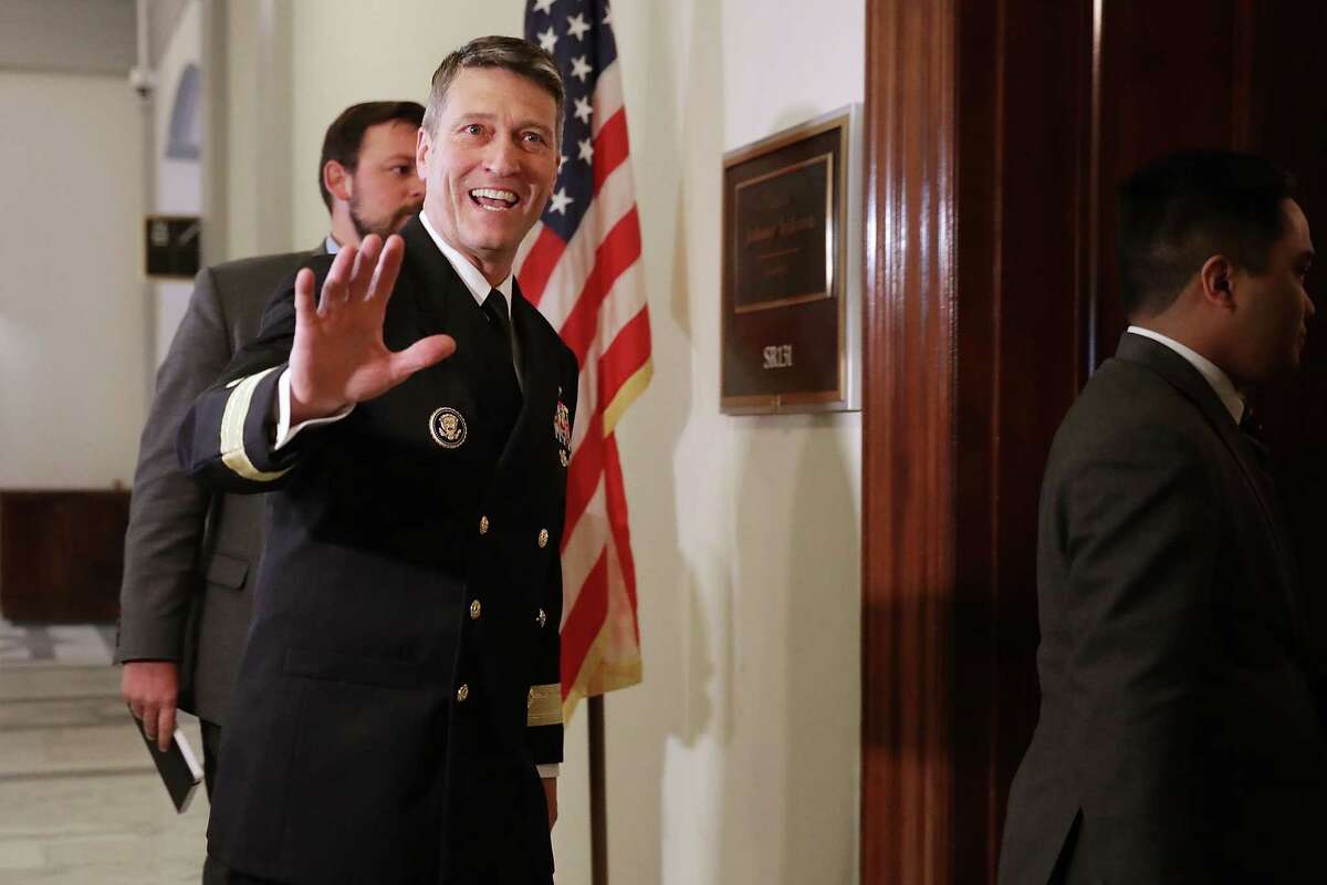 WASHINGTON, DC - APRIL 16: Physician to the President U.S. Navy Rear Admiral Ronny Jackson waves to journalists as he heads into a meeting with Senate Veterans Affairs Committee Chairman Johnny Isakson (R-GA) in the Russell Senate Office Building on Capitol Hill April 16, 2018 in Washington, DC. President Donald Trump nominated Jackson, his personal doctor at the White House, to be the new Secretary of the Department of Veterans Affairs after Trump fired David Shulkin on March 28. (Photo by Chip Somodevilla/Getty Images)