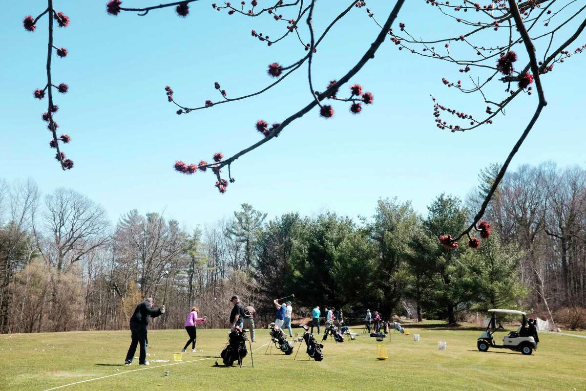 Golfers practice hitting on the driving range on opening day at Western Turnpike Golf Course on Sunday, April 22, 2018, in Guilderland, N.Y. New this year at the golf course, players can set up tee times any time day or night through the course's website. The course is also partnering with the smartphone app GolfStatus, which allows players to use the app as their score card and it also allows the course to send out special offers to players. (Paul Buckowski/Times Union)