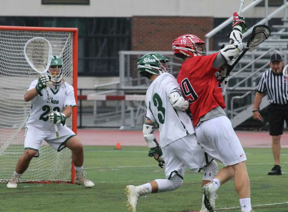 Shen defender Tim McCarthy pressures Guilderland's Connor Quimby as he looks for a shot during the Section 2 Boys' Class AA lacrosse semifinal at Shenendehowa High School Friday May 26, 2017. (Ed Burke photo - Special to The Times Union)