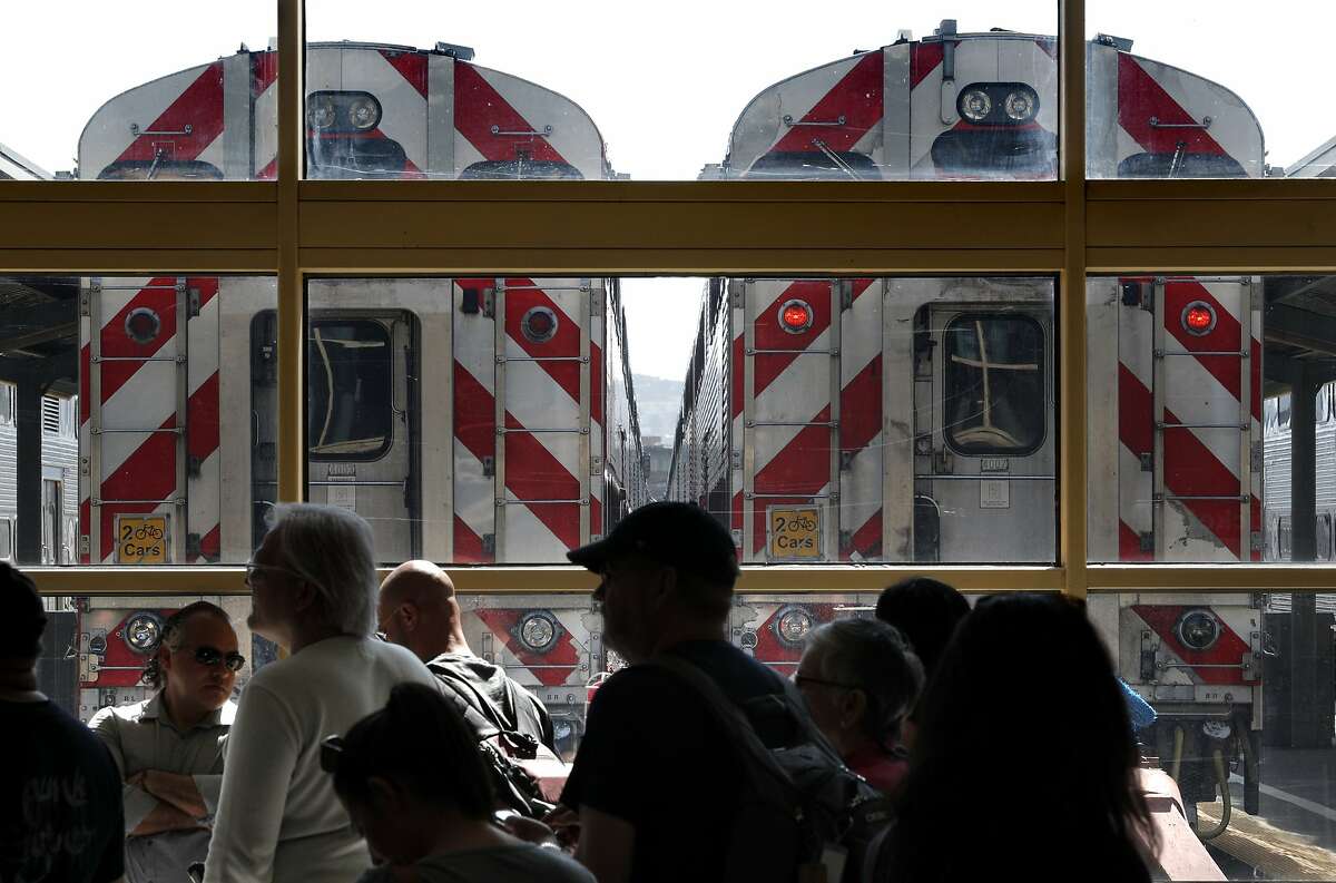 Passengers wait for their trains at the Caltrain rail station in San Francisco, Calif., on Sunday, April 22, 2018.