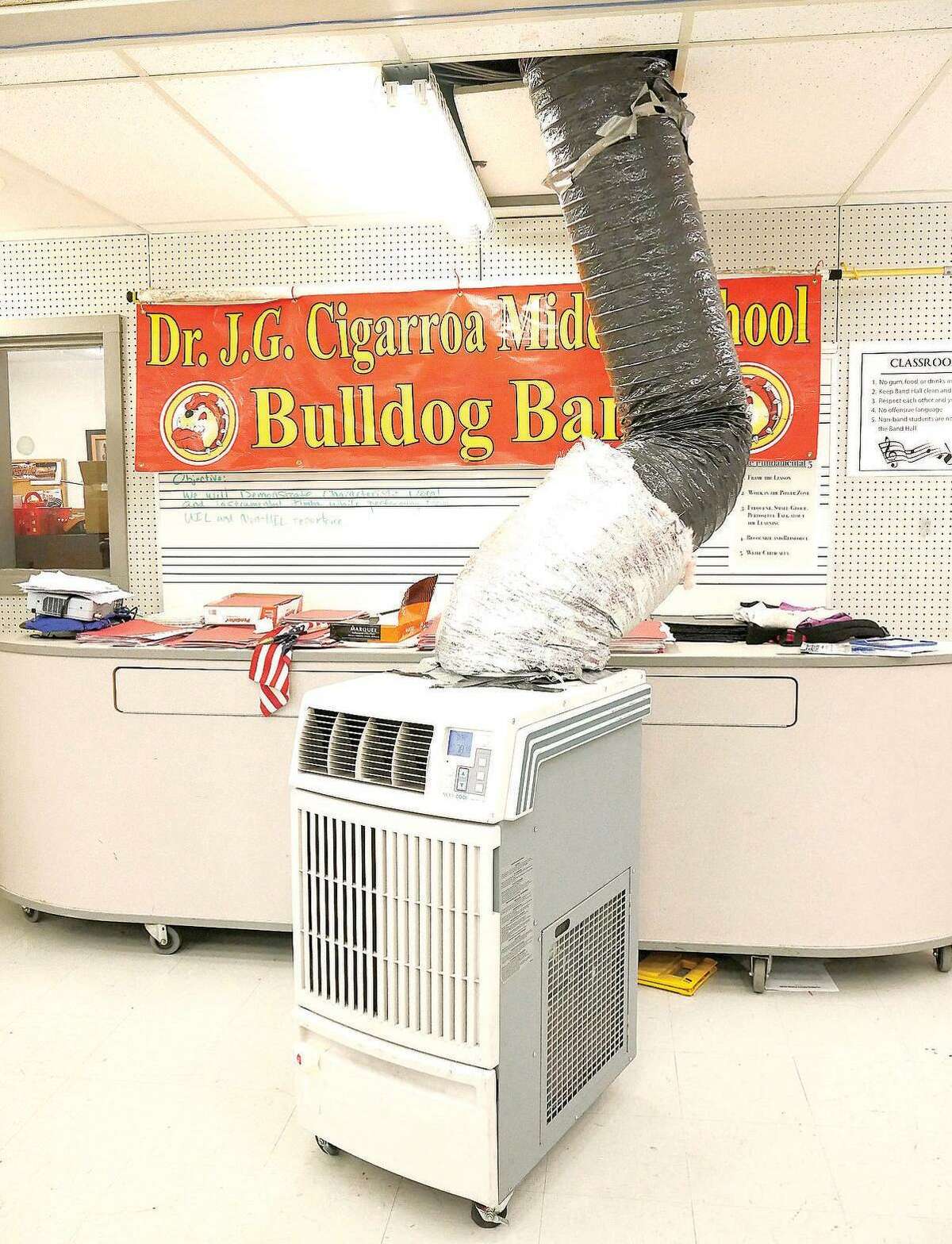 Portable air conditioning units are set up in the band and choir rooms because of the lack of central air conditioning in that wing of Cigarroa Middle School.