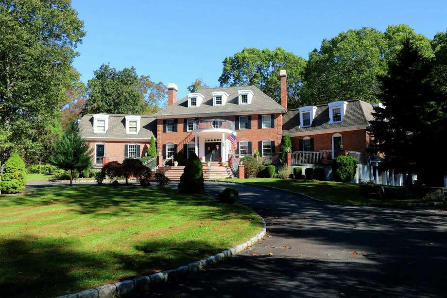 The 15-room custom red brick colonial house at 20 Cherry Lane is walking distance to Cherry Lane Park.