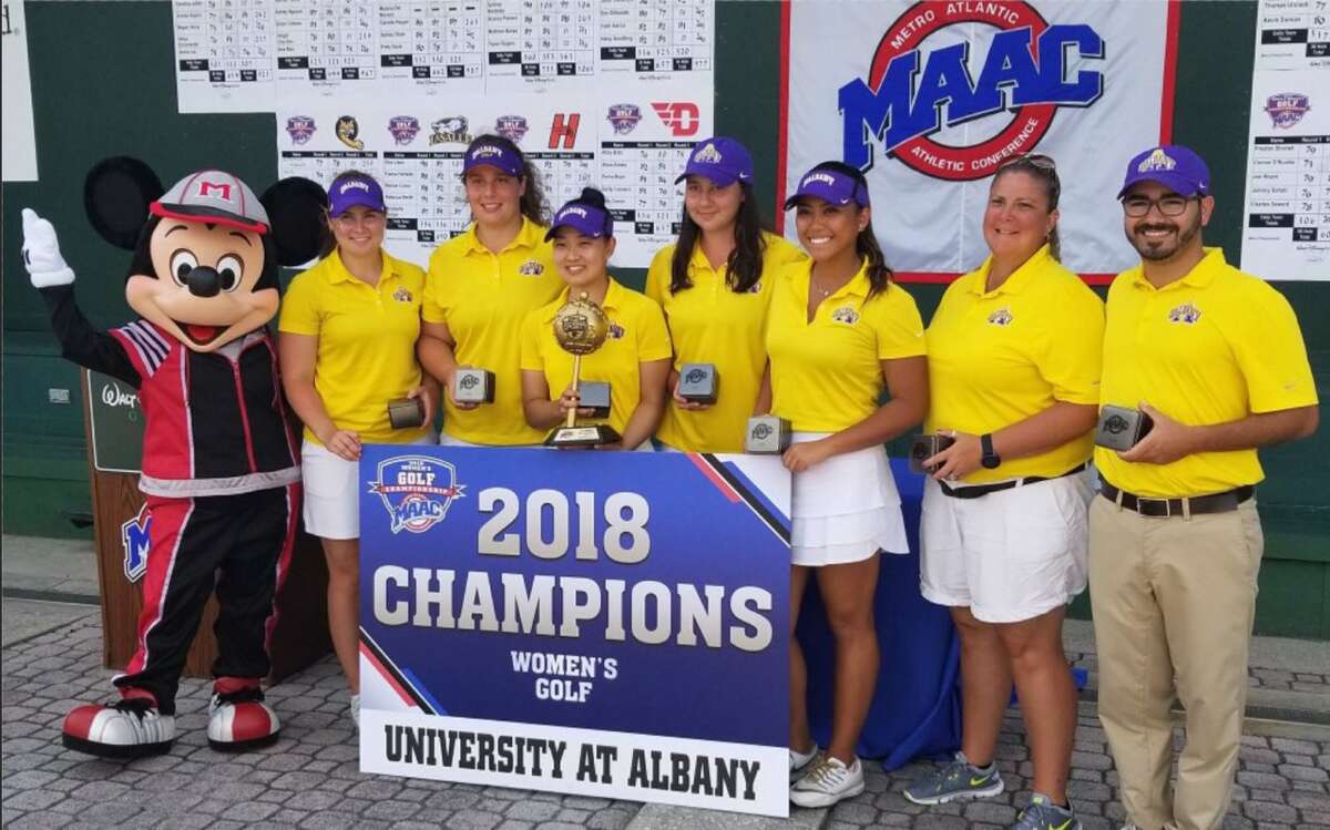 Mickey Mouse congratulations the University at Albany women's golf team Sunday, April 22, 2018, for winning the Metro Atlantic Athletic Conference championship at Disney's Magnolia Golf Course in Lake Buena Vista, Fla. Team members (from left) are Hegla Einarsdottir, Megan Henry, Annie Songuen Lee, Caroline Juillat, assistant coach Matthew Ragovin and head coach Colleen Cashman-McSween. (Photo courtesy University at Albany athletics)