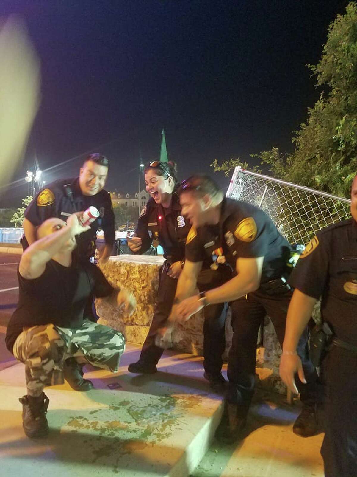 Facebook user Flawz Don Rodriguez snapped a picture of his friend Jose Garza chugging a beer while surrounded by laughing SAPD officers on Saturday.