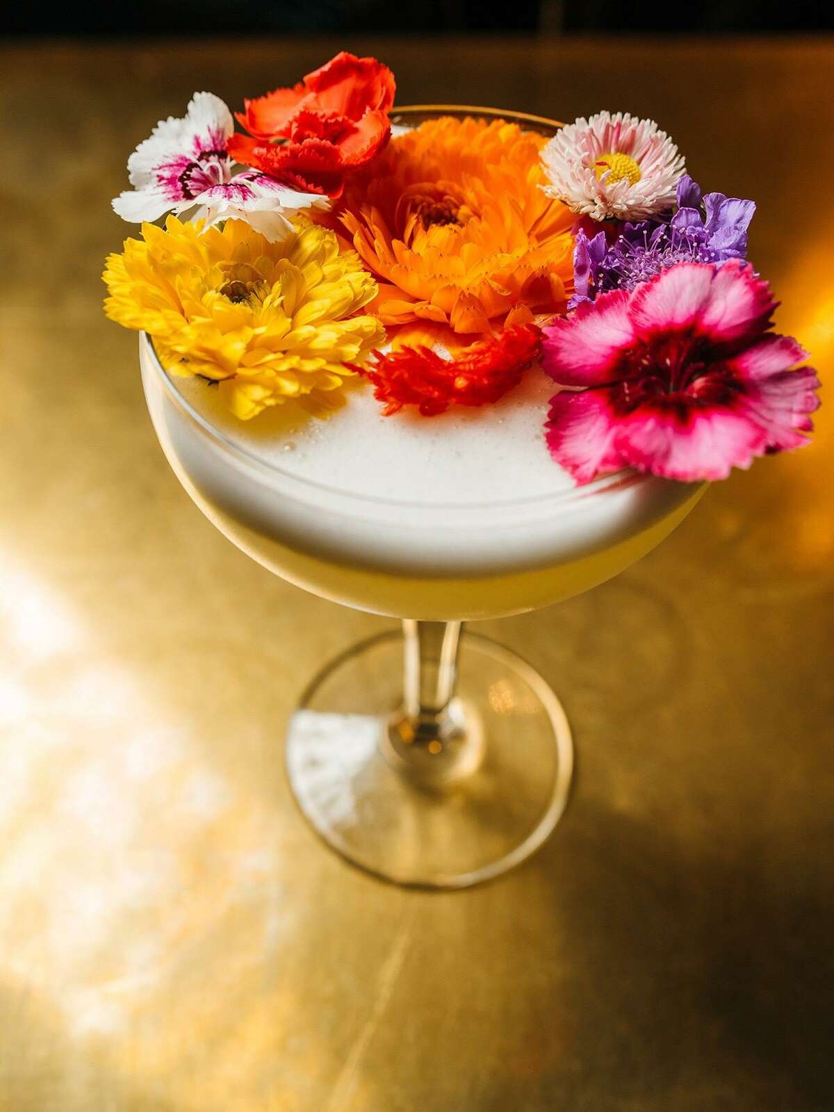 The Battle of Flowers is made with Uruapan Charanda (a take on Mexican rum originated in the State of Michoacan), passion fruit, fresh lime juice and piloncillo sugar, topped with an arrangement of edible fresh flowers. It is available at Juniper Tar, 244 W. Houston St.