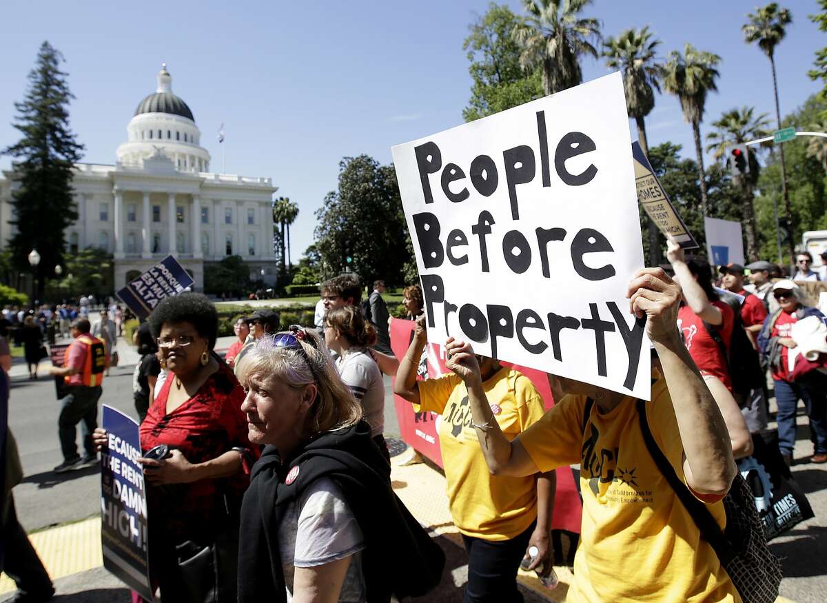 Supporters of a rent control initiative march near the Capitol calling for more rent control, Monday, April 23, 2018, in Sacramento, Calif. Backers of the initiative say they have collected enough signatures to allow voters to decide whether to repeal a 1995 law that restricts rent control. If certified by the secretary of state the initiative will appear on the November ballot. (AP Photo/Rich Pedroncelli)