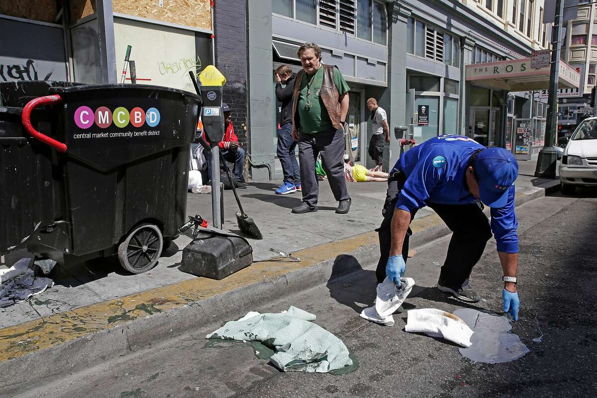 A Community Guide, (declined to give his name) cleans along 6th st. between Mission and Howard streets on Mon. April 23, 2018, in San Francisco, Calif. San Francisco City Hall politicians continue to struggle with a fix for the real public health menace on our sidewalks the dirty needles, tent encampments, feces and foul garbage.