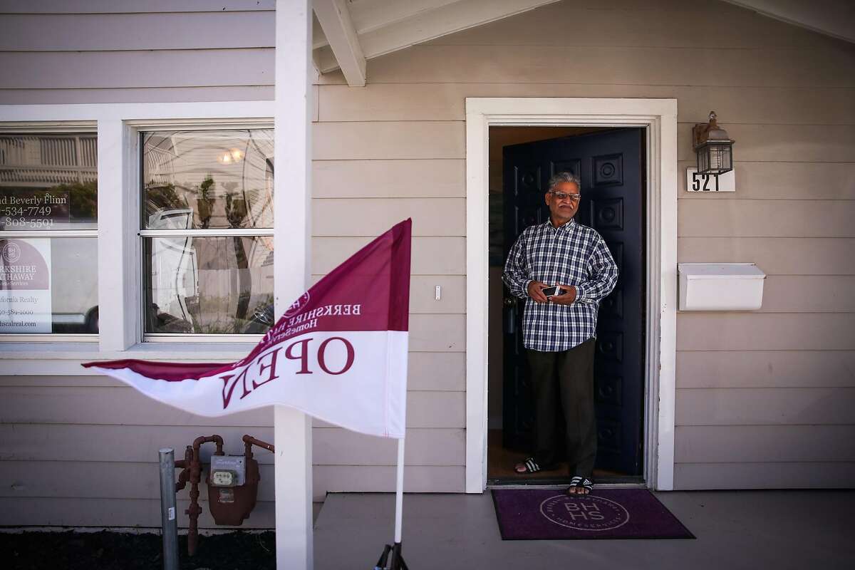 Ashok Patel stands in the doorway of a house that is for sale on 2nd Lane during an open house in South San Francisco, California, on Sunday, April 22, 2018.