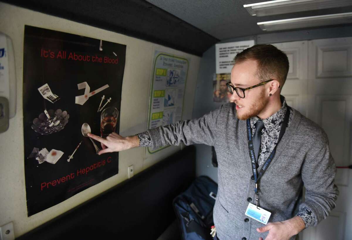 Luke Grandis, program coordinator at Project Safe Point, points to a poster in Safe Point's needle exchange van which shows lesser known ways that diseases, such as hepatitis C, can spread between IV drug users on April 11, 2018, in Albany N.Y. Bexar County officials are considering installing a needle exchange program here, but talks are in the early stage.