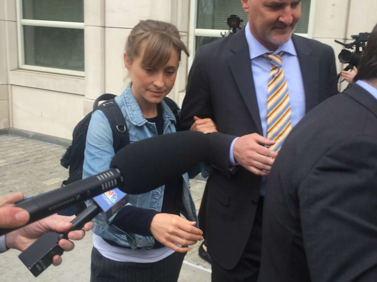 Allison Mack leaves Federal court Tuesday, April 24, 2018, in the Brooklyn borough of New York. Federal prosecutors say the television actress, best known for playing a young Superman's close friend, has been charged with sex trafficking for helping recruit women to be slaves of a man who sold himself as a self-improvement guru.