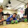 Albany High School students from left, senior Henry Thomas, junior Noah Greenblatt and sophomore Laurel Stix tinker with robot parts in the shop class on Monday, April 23, 2018 in Albany, N.Y. They and the rest of the robotics team won the regional robotics championship and is going to the national competition in Detroit on Wednesday. (Lori Van Buren/Times Union)