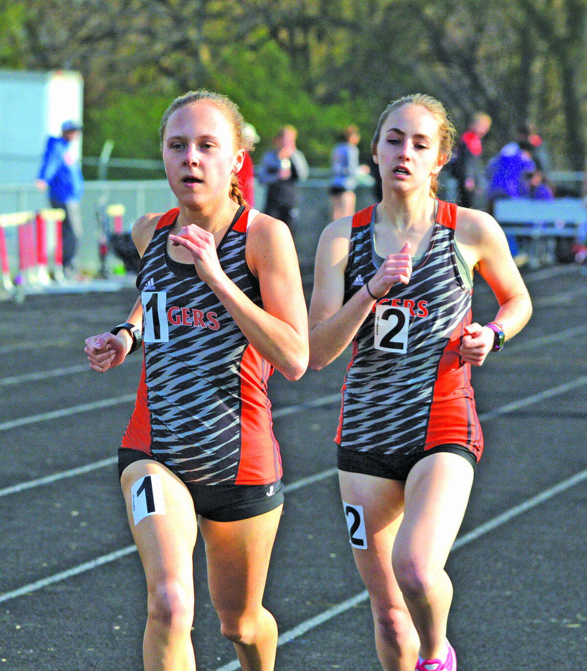 Edwardsville’s Abby Schrobilgen, left, and Hannah Stuart placed first and second, respectively, in the 3,200-meter run in Tuesday’s Madison County Large School Meet at Highland.