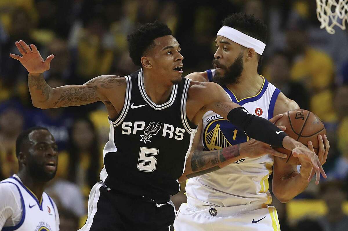 Golden State Warriors' JaVale McGee, right, keeps the ball from San Antonio Spurs' Dejounte Murray (5) during the first half in Game 5 of a first-round NBA basketball playoff series Tuesday, April 24, 2018, in Oakland, Calif. (AP Photo/Ben Margot)